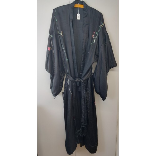 140 - A Chinese silk embroidered black robe, circa 1920s/30s. 137 cm length.
Condition report: Some age re... 