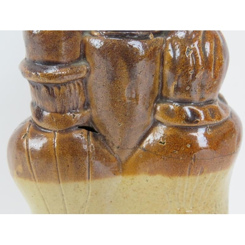 10 - A rare Victorian salt glazed stoneware flask modelled as male and female figures drinking at a taver... 