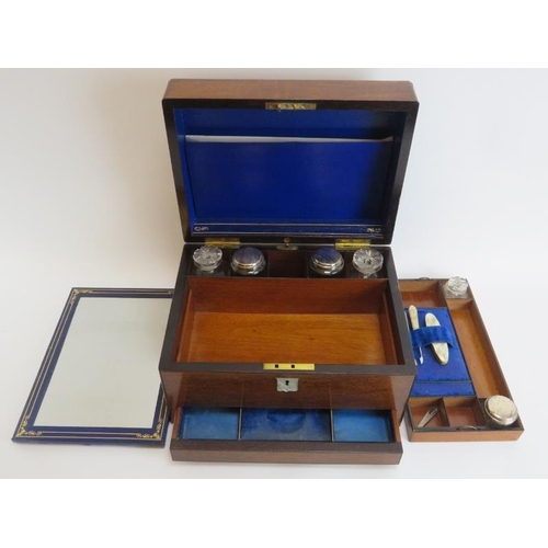 105 - A Victorian rosewood travelling toiletry / vanity dressing box. The interior housing plated silver l... 