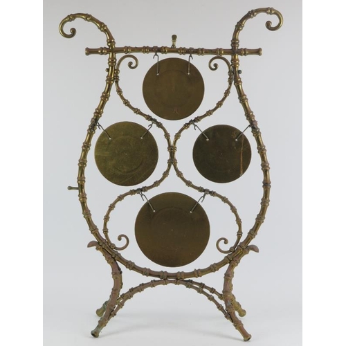 116 - A brass faux bamboo multi-tone gong of lyre form, late 19th/early 20th century. The four gongs struc... 