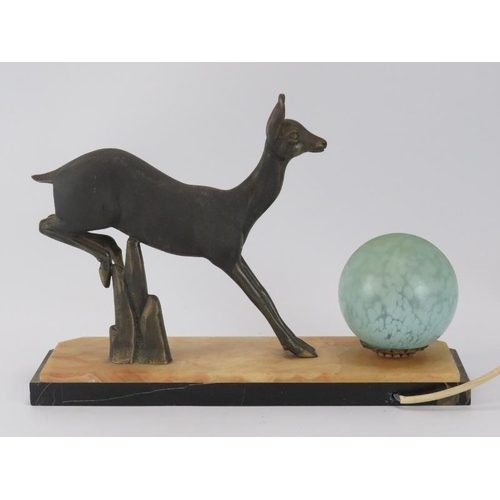 138 - An Art Deco bronzed metal deer and globular glass shaded table lamp. The mottled glass shade and bro... 