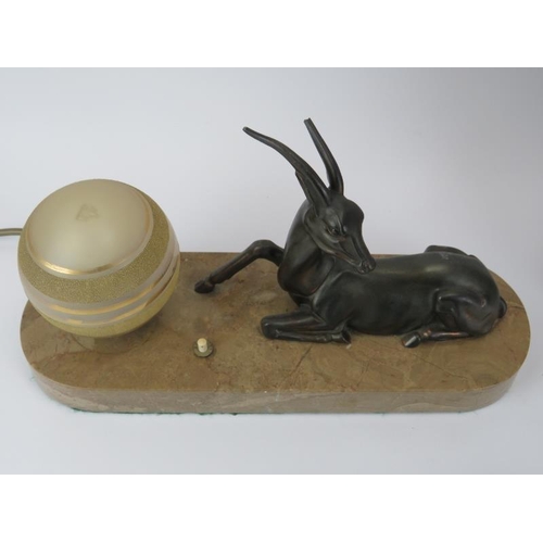 139 - An Art Deco slate and green onyx mantel clock, a bronzed metal gazelle and globular glass shade tabl... 