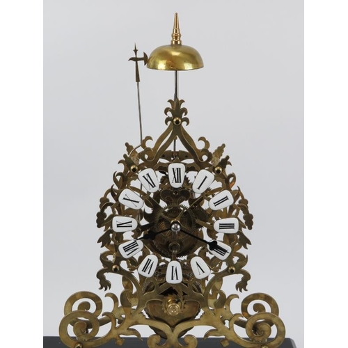 16 - A large 8-day brass skeleton clock, mid 20th century. With black enamelled numerals and chain driven... 