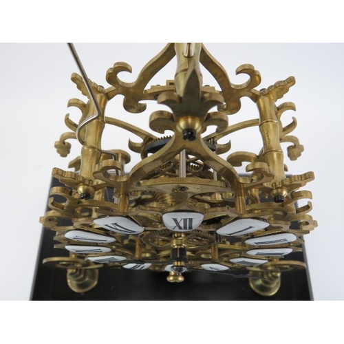 16 - A large 8-day brass skeleton clock, mid 20th century. With black enamelled numerals and chain driven... 