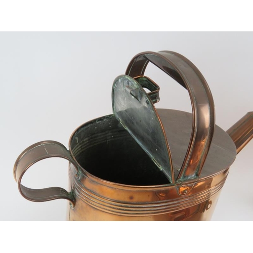 171 - Four antique copperware items. Comprising a watering can, two kettles and a large hot water flask. (... 