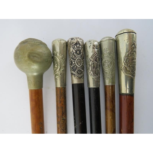 185 - Six British military silver and plated silver mounted bamboo and tapered wood swagger sticks. (6 ite... 