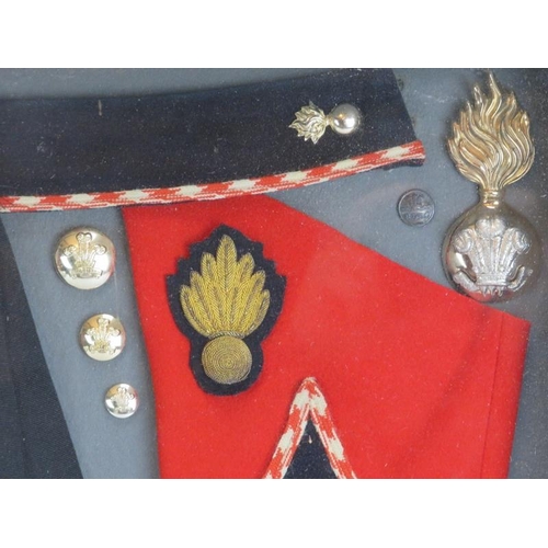 192 - A vintage Royal Welch Fusiliers uniform, buttons and badges specimen display. Framed and glazed. 59 ... 