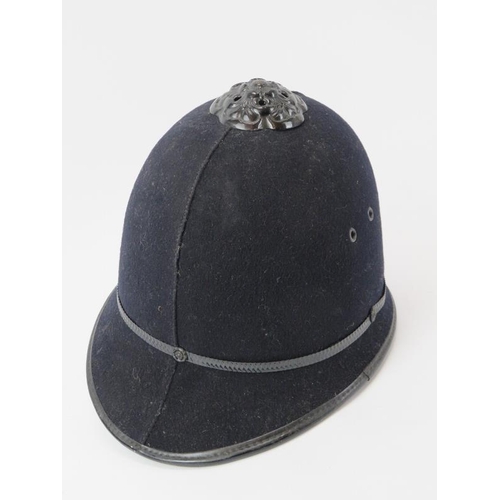 229 - A vintage Kent Constabulary police helmet, mid 20th century. With blackened rose crown mount and pla... 