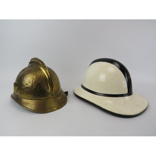 230 - A vintage French Fireman's gilt brass helmet, early/mid 20th century and a Welsh firefighters helmet... 