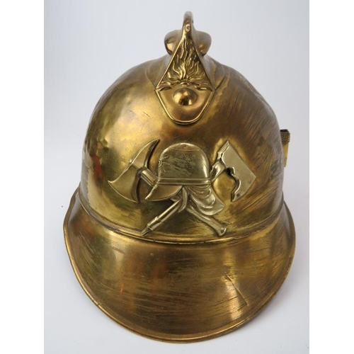 230 - A vintage French Fireman's gilt brass helmet, early/mid 20th century and a Welsh firefighters helmet... 