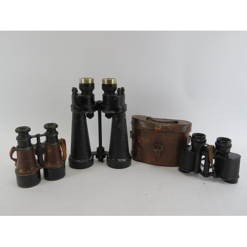 233 - Three pairs of WWII era binoculars. Barr & Stroud military issue binoculars, a French pair marked ‘P... 