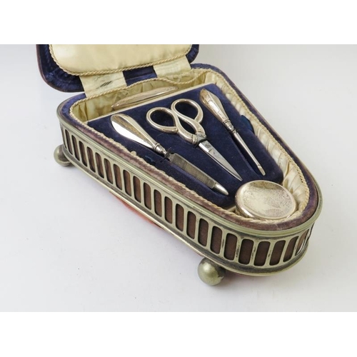 372 - An early 20th century silver mounted five piece manicure set in a blue velvet piano shaped case with... 