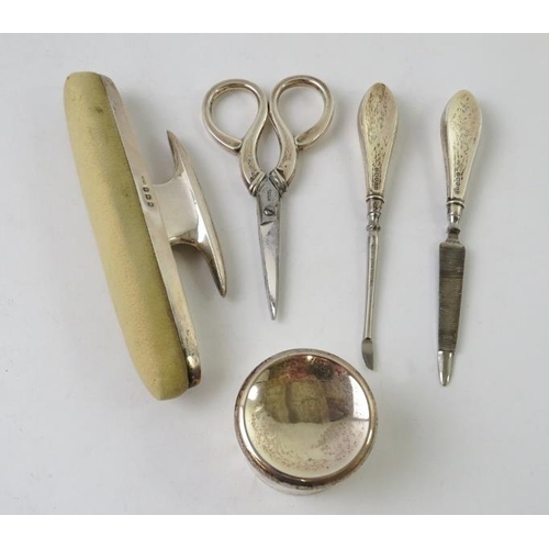 372 - An early 20th century silver mounted five piece manicure set in a blue velvet piano shaped case with... 