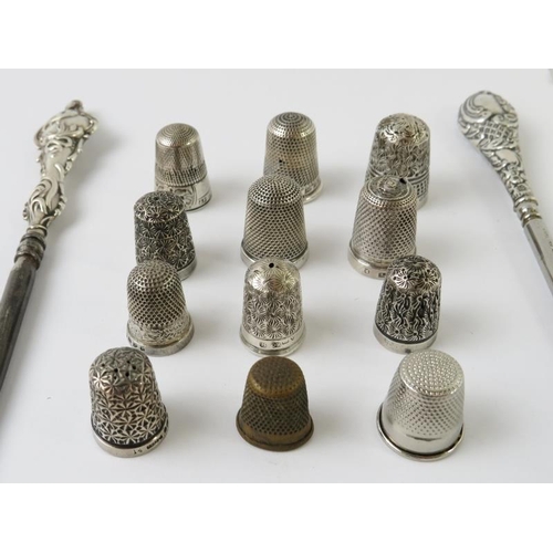 379 - Ten hallmarked silver thimbles of various design, two other thimbles, two silver handled button hook... 