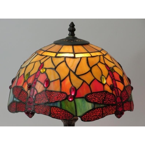 39 - A modern Tiffany style bronzed metal table lamp with coloured glass shade. The shade decorated with ... 