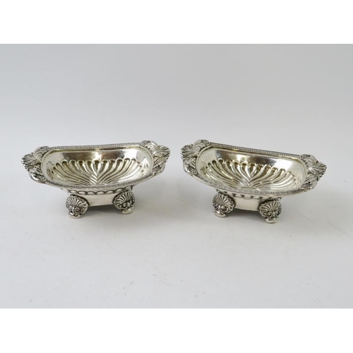 396 - A fine pair of George III rococo decorated salts with half fluted bowls and scallop feet. Hallmarked... 