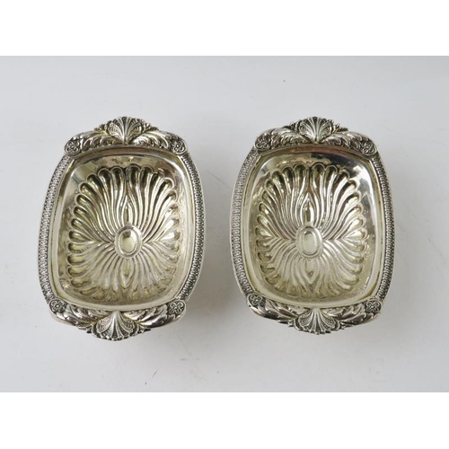 396 - A fine pair of George III rococo decorated salts with half fluted bowls and scallop feet. Hallmarked... 