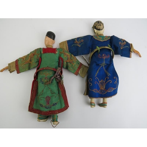 40 - A pair of Chinese wooden peg dolls depicting an emperor and empress wearing embroidered silk Imperia... 