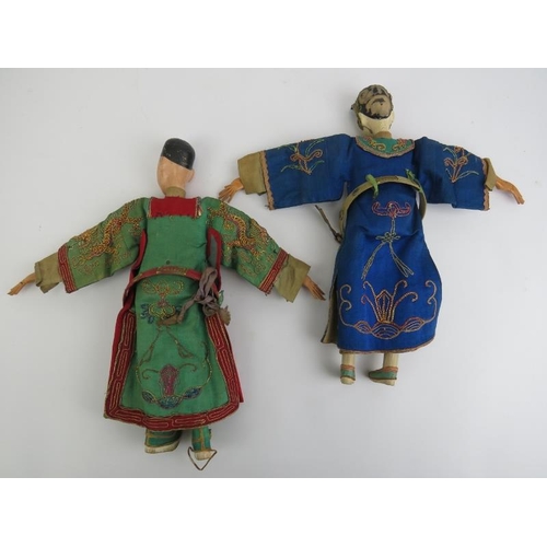 40 - A pair of Chinese wooden peg dolls depicting an emperor and empress wearing embroidered silk Imperia... 