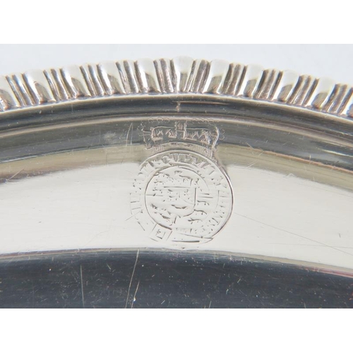 401 - A fine early George III silver platter with gadrooned rim and various engraved crests. Hallmarked fo... 