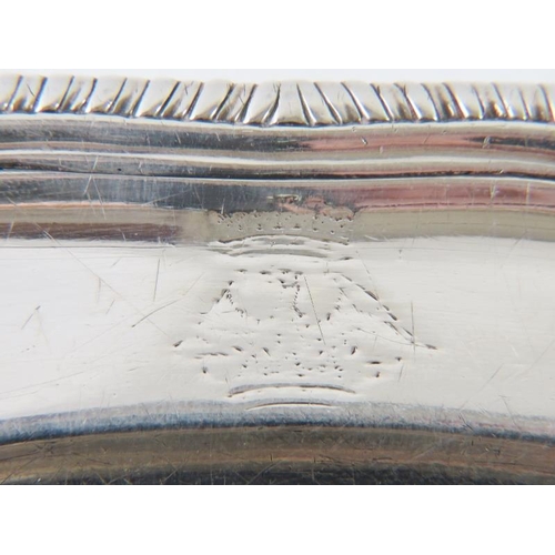 402 - A fine George III silver platter with gadrooned rim and engraved crest (very rubbed). Hallmarked for... 