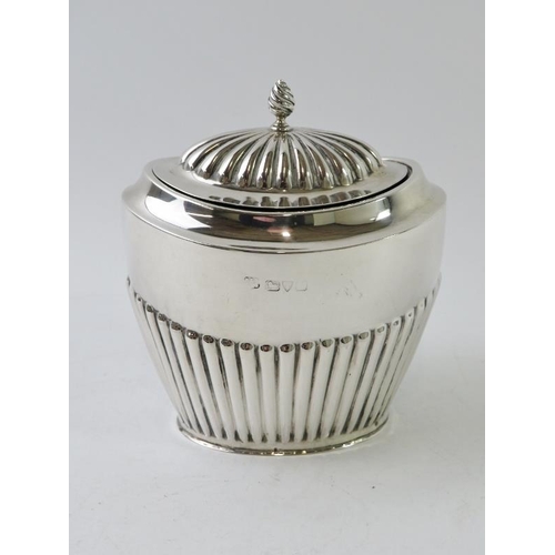 404 - An early 20th century silver tea caddy with half fluted decoration and gilded interior, hallmarked f... 