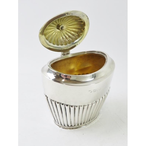 404 - An early 20th century silver tea caddy with half fluted decoration and gilded interior, hallmarked f... 