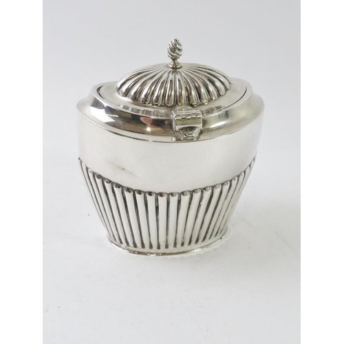 404 - An early 20th century silver tea caddy with half fluted decoration and gilded interior, hallmarked f... 