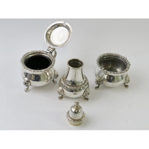 406 - A good quality Harrods silver three piece Georgian style cruet set with gadrooned rims, lion mask le... 