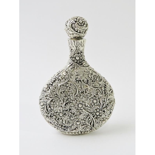 408 - A highly ornate Chinese white metal perfume bottle with extensive floral and foliate decoration, mar... 