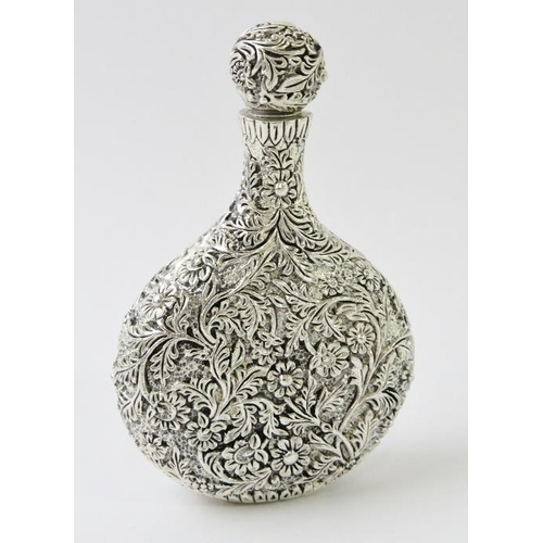 408 - A highly ornate Chinese white metal perfume bottle with extensive floral and foliate decoration, mar... 