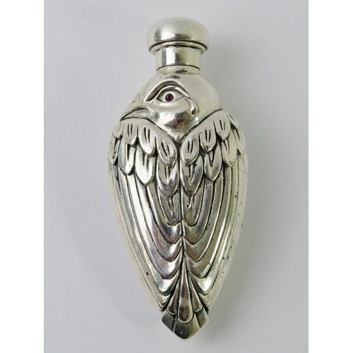 414 - An ornate figural Continental white metal double sided perfume bottle in the form of a bird with pas... 