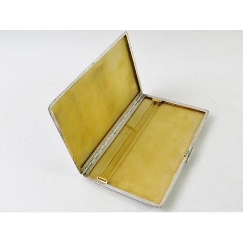 415 - A 1950s Art Deco Revival silver cigarette case with engine turned decoration and guilded interior. H... 