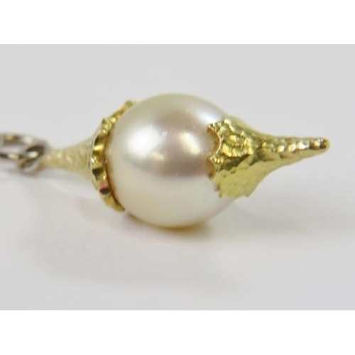 452 - A cultured pearl pendent, the golden pearl approx 10.50 - 11.00mm diameter with textured satin yello... 