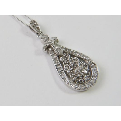 454 - A pretty 9ct white gold and diamond pendant, the drop shaped pendent all-over set with round brillia... 