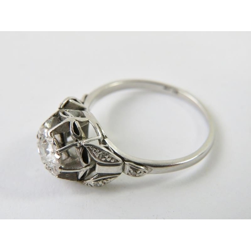 466 - A diamond single stone ring, the round old cut diamond in a raised illusion setting with single cut/... 