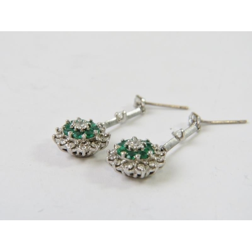 473 - A pair of emerald and diamond drop cluster earrings, the round brilliant diamond and emerald drop cl... 