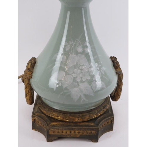 48 - A French ormolu mounted pâte-sur-pâte decorated celadon glazed porcelain table lamp, 19th century. O... 