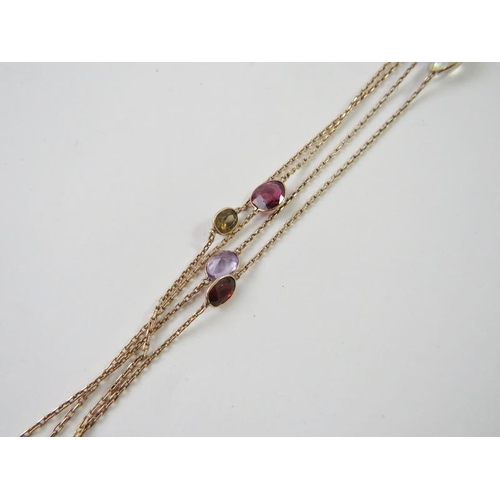 488 - A long chain spectacle set with oval faceted gemstones and round beads to include quartz, garnets, s... 