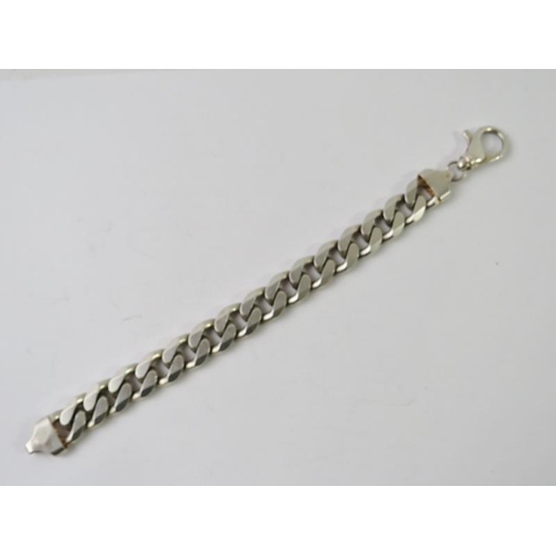 495 - A heavy silver retro flat curb link bracelet, marked 925 and bearing full import hallmarks. Overall ... 