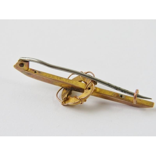 496 - An antique yellow metal bar brooch with nautical life ring detail and steel pin. Marked 9CT GOLD XL.... 