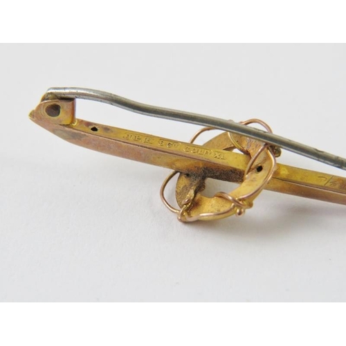 496 - An antique yellow metal bar brooch with nautical life ring detail and steel pin. Marked 9CT GOLD XL.... 