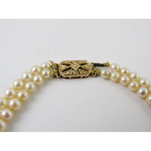 498 - A double string cultured pearl necklace with 9ct gold clasp, fully hallmarked for London 1986. Lengt... 