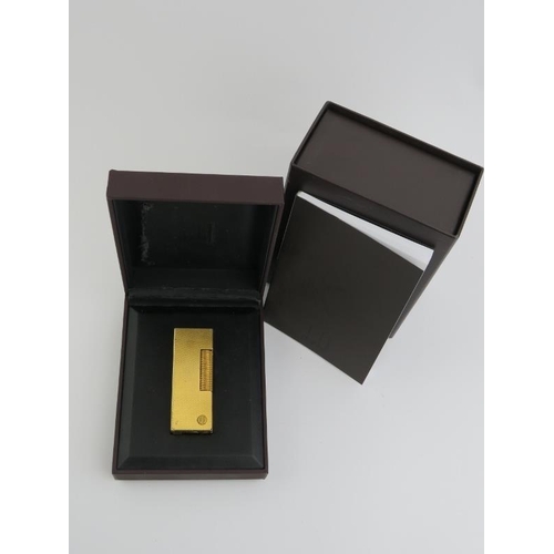 60 - A vintage Dunhill Rollagas rolled gold plated lighter. With presentation box and paperwork. 6.4 cm l... 