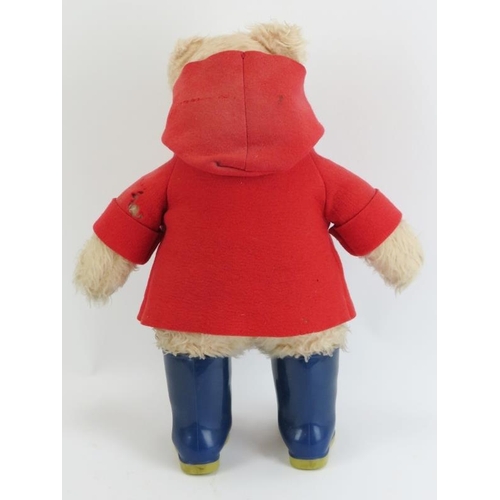 7 - A large Paddington Bear by Gabrielle Designs, circa 1970s/80s. With red duffle coat, blue Dunlop wel... 