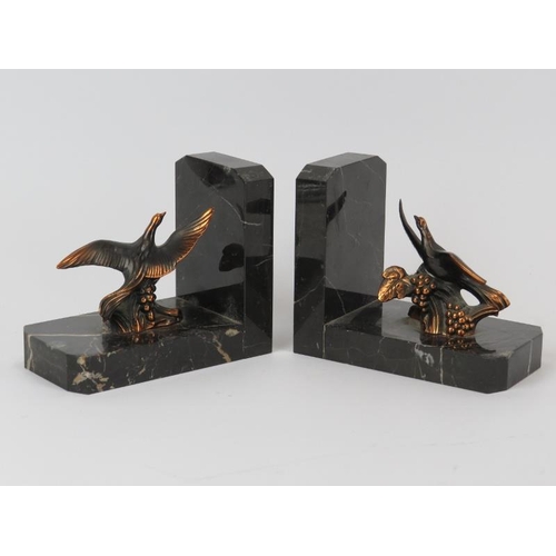 82 - A pair of vintage black marble bookends mounted with bronzed copper birds. Bases modelled in the Art... 