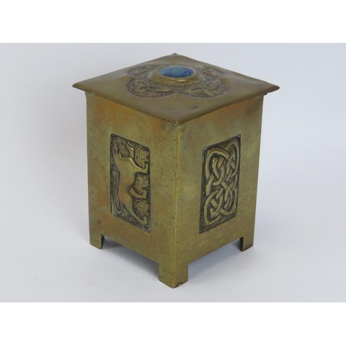 85 - An Arts & Crafts brass tea caddy, late 19th/early 20th century. The cover decorated with a quatrofoi... 