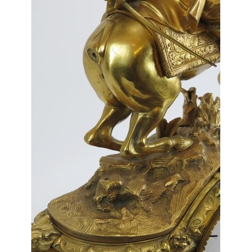 9 - A Belgian gilt bronze French style mantel clock, 19th century. Surmounted with a cavalier on horseba... 