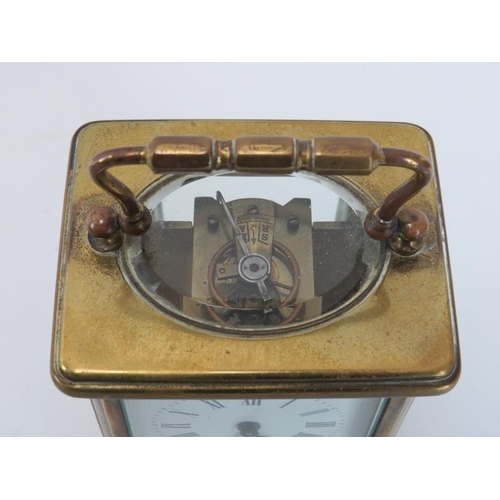 91 - An antique gilt brass carriage clock, late 19th/early 20th century. With a white enamelled Roman num... 