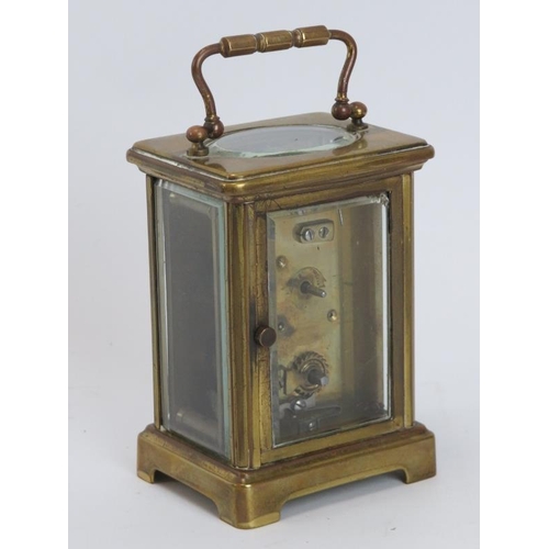 91 - An antique gilt brass carriage clock, late 19th/early 20th century. With a white enamelled Roman num... 